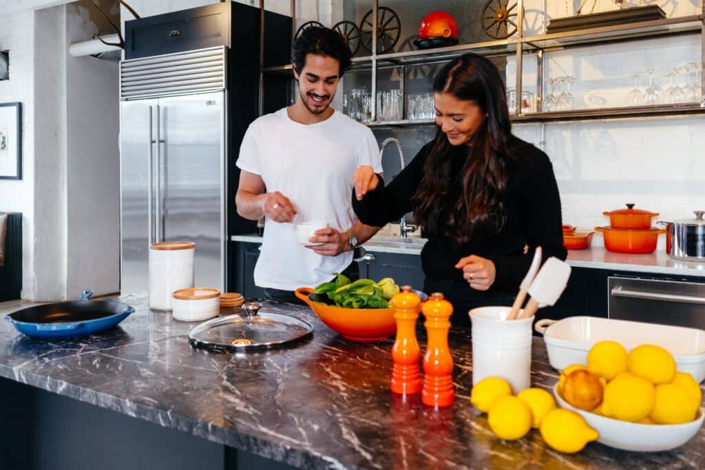 Couple cooking on a granite top.